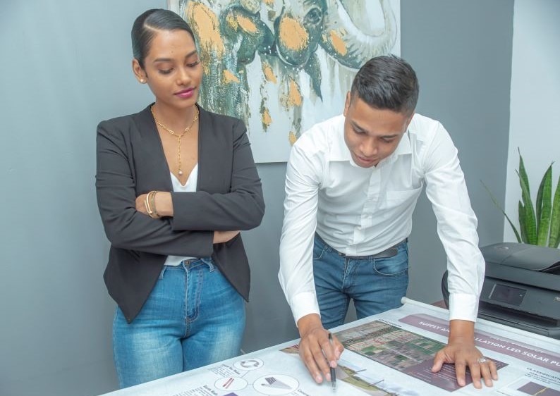 A male and female of M&P using specialized project management techniques to oversee the planning and design.